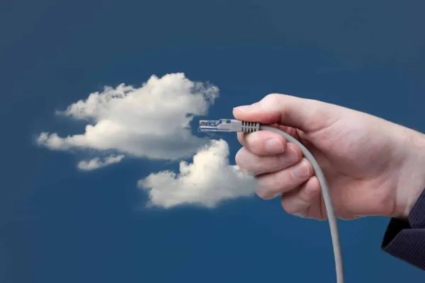Cloud computing concept. Hand with ethernet cable connecting into cloud. | Architectural Firm More Profitable with IT Cloud