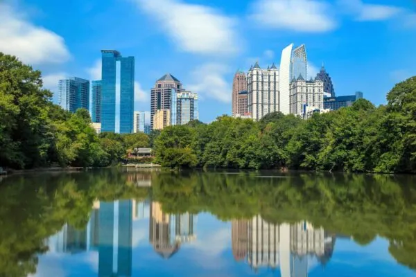 Skyline and reflections of midtown Atlanta, Georgia in Lake Meer from Piedmont Park. | AISC to Honor 13 Leading Design, Construction, and Education Professionals at the 2020 NASCC: The Steel Conference