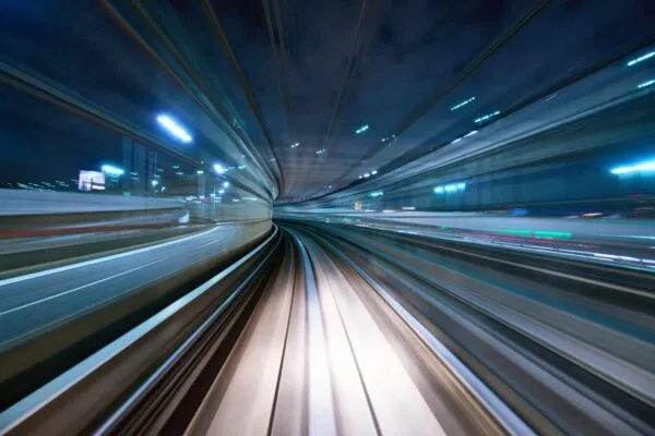 Motion blur of a city and tunnel from inside a moving monorail in Tokyo. | Mark Alisesky Joins Urban Engineers as Senior Project Manager for Rail and Transit