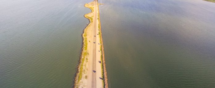 Panorama aerial view famous Texas City Dike, a levee that projects nearly 5miles south-east into mouth of Galveston Bay. It was designed to reduce the impact of sediment accumulation along lower Bay