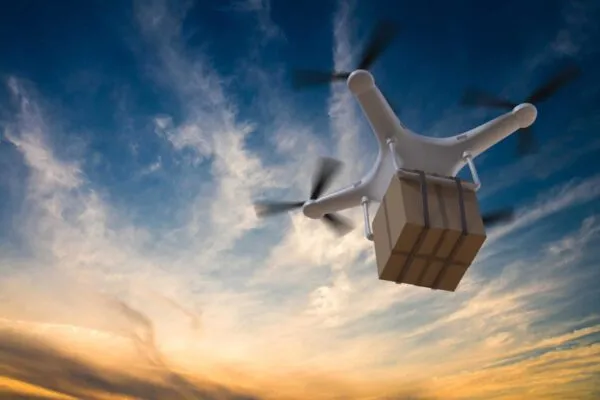3D rendered illustration of drone flying in the sky and delivering a package at sunset. | Autonomous Technology Can Mitigate the Business Impact of the Coronavirus (COVID-19)