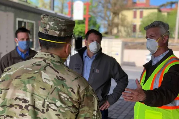 U.S. Army Corps of Engineers Maj. Gen. R. Mark Toy is briefed by Tarlton leaders about the 100-plus skilled trades workers who worked around the clock to complete the alternate care facility. Pictured are (from left) Senior Project Manager Cameron Denison, who managed the night team; Vice President Joe Scarfino, who led the effort and managed the day team; and Executive Vice President John Doerr.  | Tarlton Completes Missouri’s First COVID-19 Alternate Health Care Facility