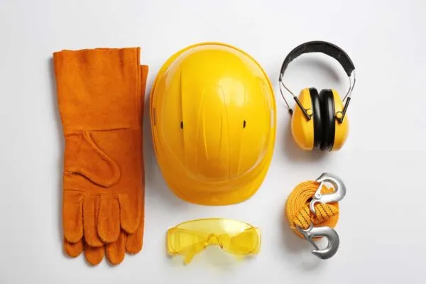 Flat lay composition with safety equipment on white background | 6 Essential Safety Principles for New Engineers