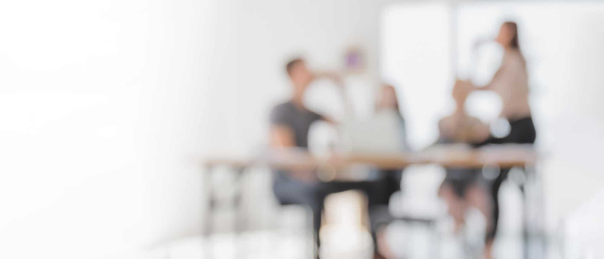 Abstract blurred interior modern office space with business people working  banner background with copy space. - Civil + Structural Engineer magazine