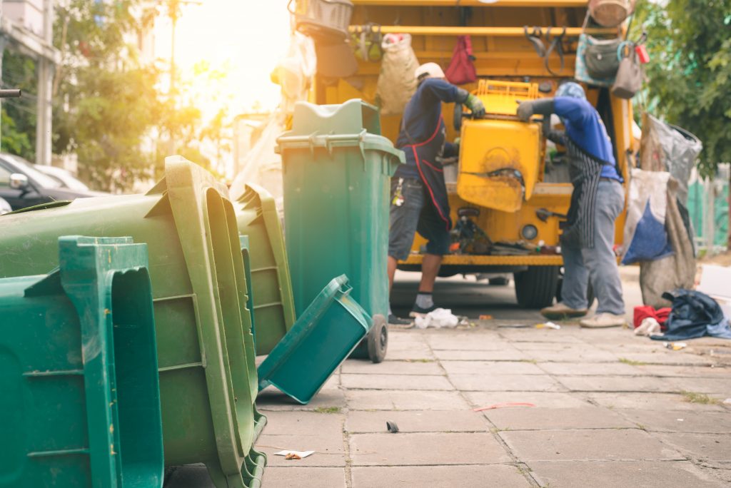 Garbage collector on the garbage truck.Sweeper or Worker are loading