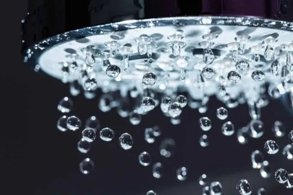 Shower Head with Water Stream on Black Background | New Report Shows U.S. Water Utilities Sector Still in Early Stages of Digital Transformation