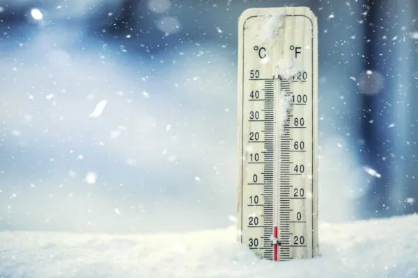 Thermometer on snow shows low temperatures under zero. Low temperatures in degrees Celsius and fahrenheit. Cold winter weather twenty under zero. | Assessment of Energy System Reliability Failures During the Extreme Cold Weather Event in the ERCOT Region
