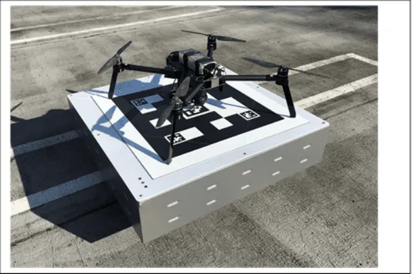 Drone Outfitted with WiBotic’s OC-251 Onboard Charger, Sitting Atop a WiBotic PowerPad (TR-301 Transmitter in an Enclosure) | WiBotic Secures Two CE Marks for Robot Wireless Charging Systems