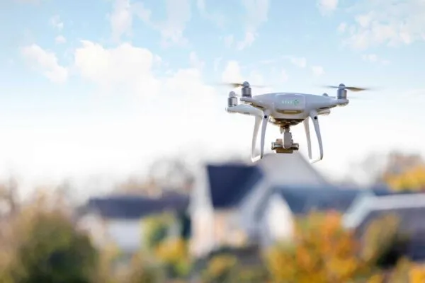 drone flying front of home | Technology as an Investment, Not a Cost