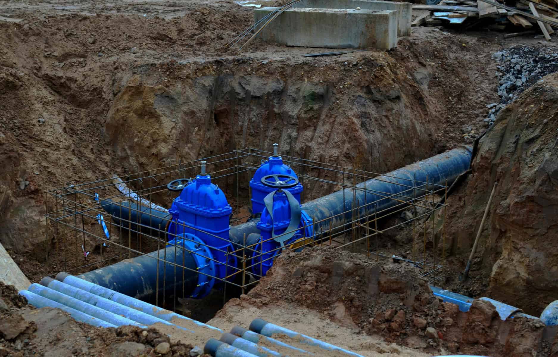 Laying underground storm sewers at construction site, water main, sanitary sewer, drain systems.  Groundwater system for new residential buildings in the city. Ball valve background. Small sharpness | Common Ground Alliance Releases Newest Edition of Best Practices Guide