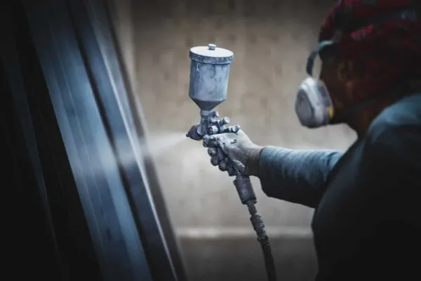 Man painting metal products with a spray gun | Thermal Spray Coating Market to Eyewitness Massive Growth by 2025