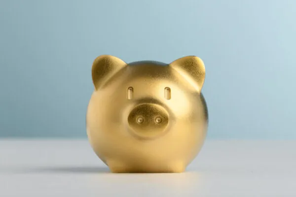 Golden Piggy Bank with blue background for saving and invest concept. | Now is the Time to Invest in Our Workforce