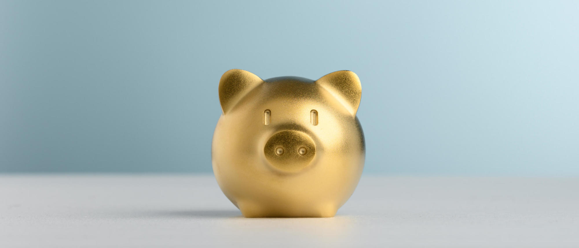Golden Piggy Bank with blue background for saving and invest concept. | Now is the Time to Invest in Our Workforce