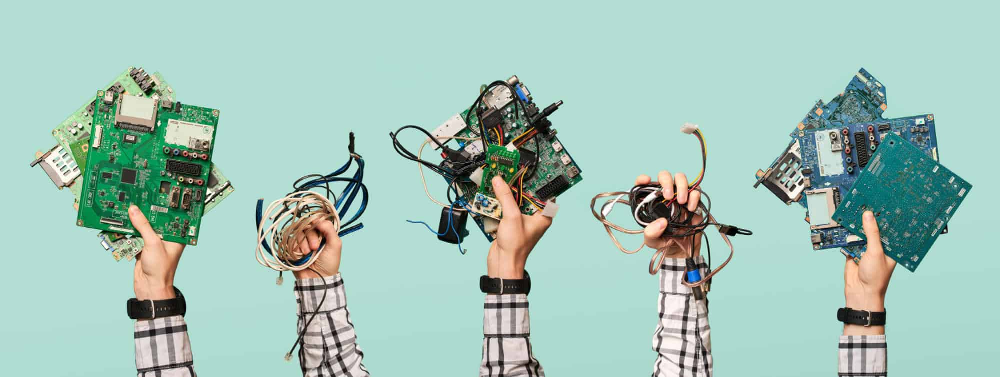Five hands hold electrical waste on blank blue background. Ecological clean garbage concept. | Microsoft Agrees to Expand Consumers’ Repair Options