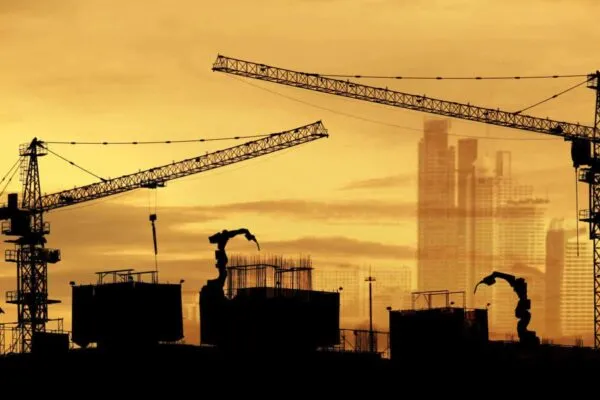 tower cranes at construction site and city background | Global construction equipment market size to reach USD 222.79 billion valuation by 2027