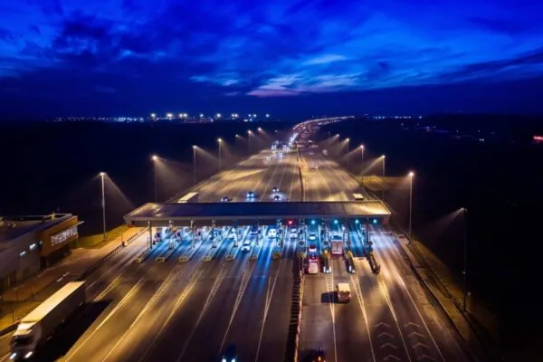 Aerial drone view on motorway with toll collection point at night | ETC Awarded Contract to Be the New Electronic Toll Collection System Provider for Central Texas Regional Mobility Authority