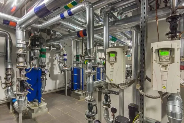 Modern independent heating system in boiler room. Pipelines, water pump, valves, manometers | Standard Lithium Signs Letter of Intent With Koch Engineered Solutions to Support Commercial Lithium Project Development