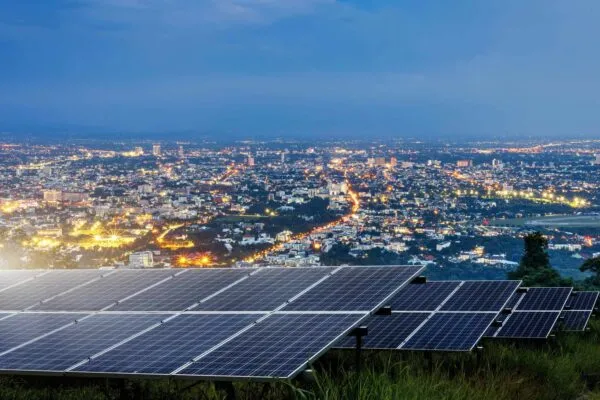 Solar panel with city night architecture electric energy light background,clean Alternative power energy concept. | Generac Announces the Closing of Its Acquisition of ecobee Inc.