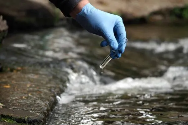 Water sample. Gloved hand into the water collecting tube. Analysis of water purity, environment, ecology - concept. Water testing for infections, harmful emissions | Worldwide Water Treatment Chemicals Market Expected to Reach USD 72.93 Billion by 2028 – Says Vantage Market Research