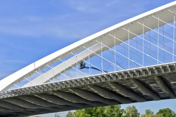 electrical installation work on the new Troja  bowstring arch bridge made from prestressed concrete and steel across the river Vltava at Prague, Czech Republic | Precast/Prestressed Concrete Institute Announces 2022 PCI Design Awards Winners