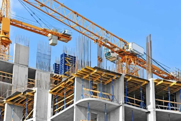 Crane and building construction site against blue sky | Nonresidential Construction Spending Flat in November, Says ABC
