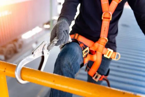 Construction worker use safety harness and safety line working on a new construction site project.Harness is a equipment for safety in construction site. | Safety Veteran Joins ABC as Senior Director of Health and Safety