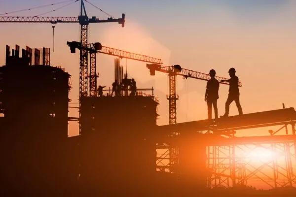 Silhouette Two engineers consult and inspect high-rise construction work over blurred industry background with Light fair.Create from multiple reference images together | New Study from Dodge Construction Network Reveals Digital Transformation Led By Construction Owners