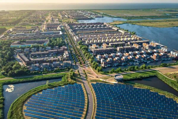 Modern sustainable neighbourhood in Almere, The Netherlands. The city heating (stadswarmte) in the district is partially powered by a solar panel island (Zoneiland). Aerial view. | Aircuity CEO on 2022: Big Focus on ESG & Decarbonization for our Life Sciences and Higher Ed Clients