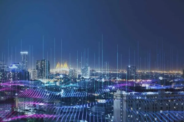 Smart city and big data technology concept background with night megapolis city and illuminated by high-speed lines going up | BST Global & HNTB Establish Strategic Partnership