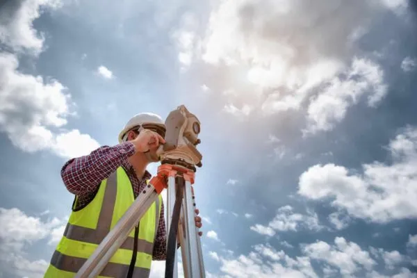 Surveyor equipment. Surveyor’s telescope at construction site or Surveying for making contour plans are a graphical representation of the lay of the land before startup construction work | COLLIERS ENGINEERING & DESIGN AQUIRES KFW ENGINEERS + SURVEYING