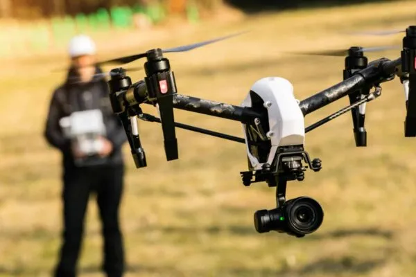 Man handling drone in nature, focused on drone | BBI International Announces UAS Industry Directory Publication