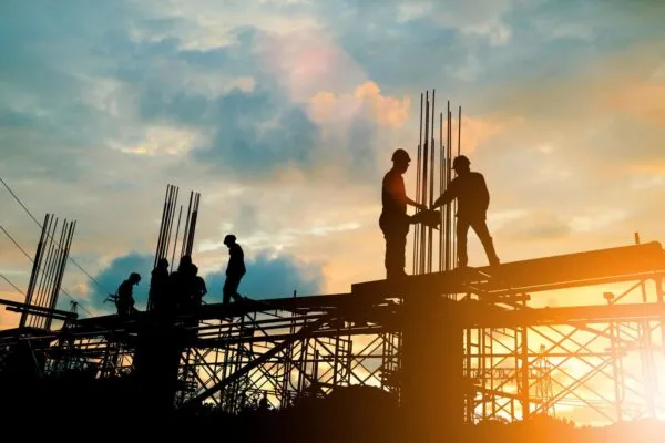 Silhouette of engineer and construction team working at site over blurred background sunset pastel for industry background with Light fair. | Gilbane Cuts Construction Project Time by 25 Percent with Matterport Digital Twins