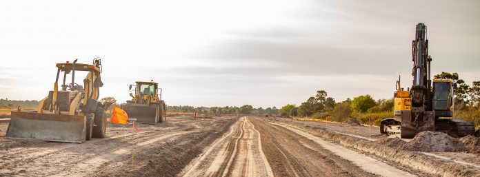 A new road is under construction with several pieces of heavy eq
