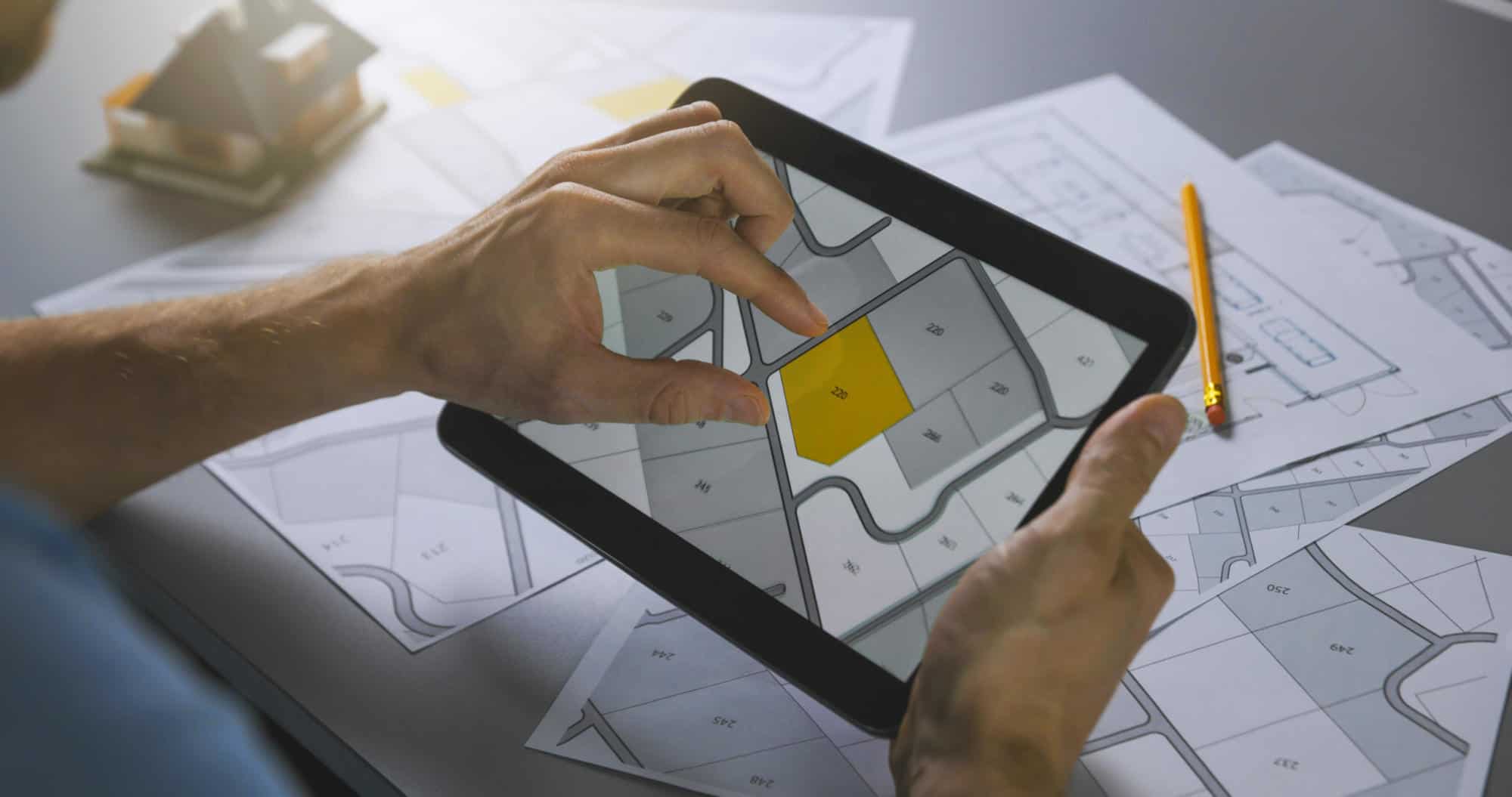 man searching building plot to buy on cadastral plan for house construction on digital tablet | Urban Planning and Design Software Market Worth $4.53Bn, Globally, by 2028 at 6.5% CAGR – Exclusive Report by The Insight Partners