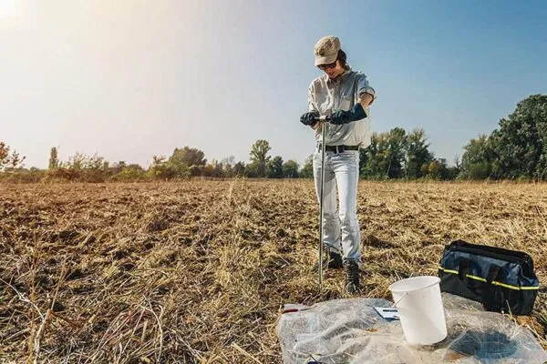 A female agronomist takes a sample with soil probe sampler. Purdue University engineers have created a suite of technologies to enhance methods to detect, identify and quantify chemicals in a range of natural, industrial and consumer settings. (Photo Credit: iStockphoto.com) | Purdue innovations enable high-quality chemical analysis beyond the lab
