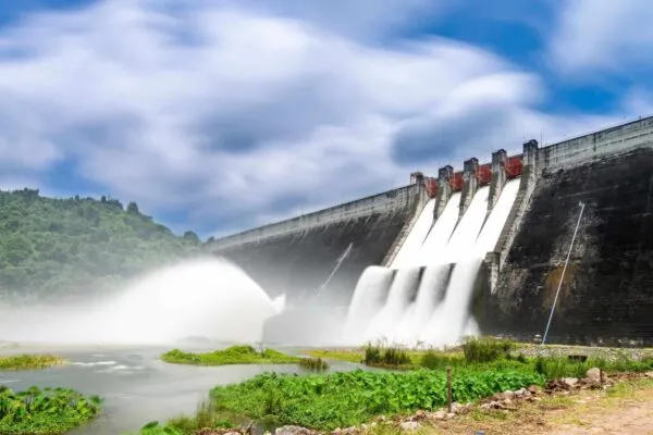 Long exposure photo of water release at spillway or overflows at big dam with blue sky and clouds (Khun Dan Prakan Chon dam in Nakhon Nayok province Thailand) | APTIM Helps to Protect 30,000 Coastal Residents with Bayou Chene Floodgate