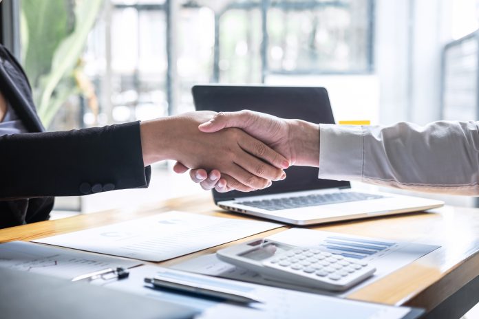 Finishing up a conversation after collaboration, handshake of tw