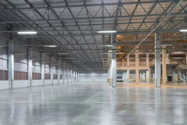 Empty factory building or warehouse building with concrete floor for industry background. | When and Why to Choose MCI®-2026 Floor Coating  for Concrete Longevity