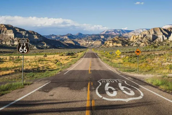 Scenic view of  famous Route 66 in classic american mountain scenery at sunset | The Mother Road, the Road of Flight
