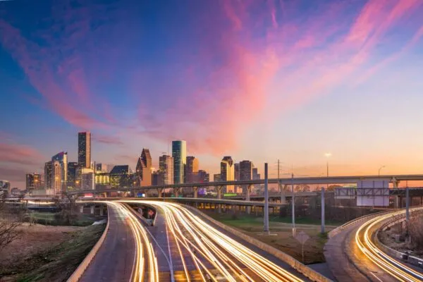 Houston, Texas, USA downtown skyline over the highways at dusk. | Derq Partners with Paradigm to Bring Industry-Leading AI Video Analytics and Connected Infrastructure Solutions to Texas