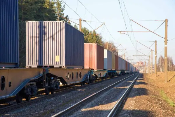 Cargo containers transportation on freight train by railway. Coronavirus Wreaks Havoc On Global Industry. Global economy is heading into a recession thanks to the widening fallout from the COVID-19 | IIJA and the Need for Multimodal Traffic Transformation