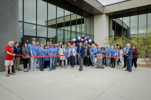 MTE's President, Ahsan Javed, is surrounded by MTE executive leadership, staff, and representatives from the Menomonee Falls Chamber of Commerce as he cuts a red ribbon to commemorate the company's grand opening of its new flagship headquarters. | MTE Corporation Celebrates Grand Opening of Flagship Headquarters