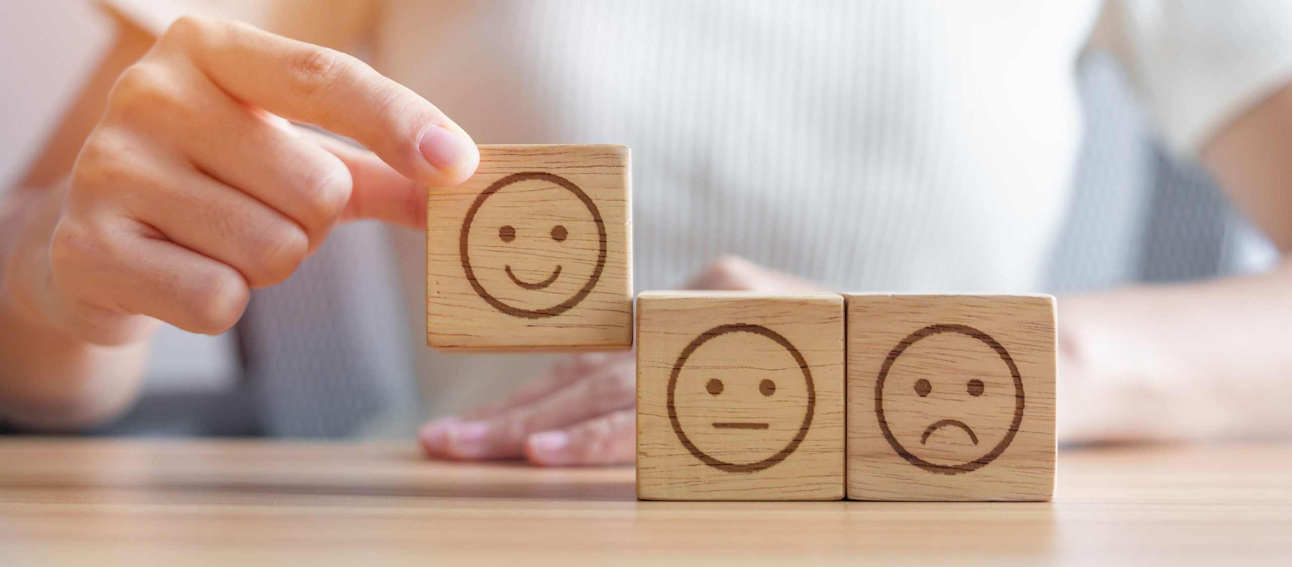 Hand choosing smile face from Emotion block.  customer review, good experience, positive feedback, satisfaction, survey, rating service, assessment, mood, world mental health day concept | Actions speak louder than words