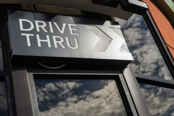 Coffee drive thru sign with reflect from glass window | Bowman Awarded Contract for More than 25 Dutch Bros Drive-Thru Coffee Sites
