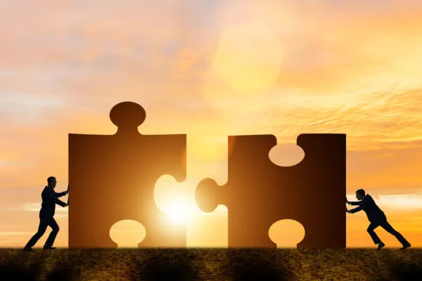 Business concept of teamwork with jigsaw puzzle | Common Ground Alliance’s Damage Prevention Institute Acquires Gold Shovel Association, Welcomes New Participants