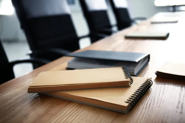 Notebooks on table indoors. Business meeting in conference hall | Metal Building Manufacturers Association Announces2023 Board of Directors