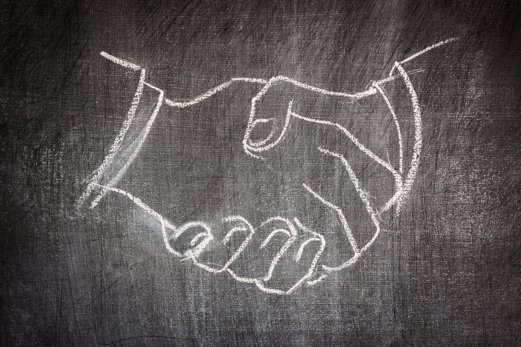 business deal handshake illustrated on a blackboard in white chalk scratched | RMA Announces the Acquisition of C Below