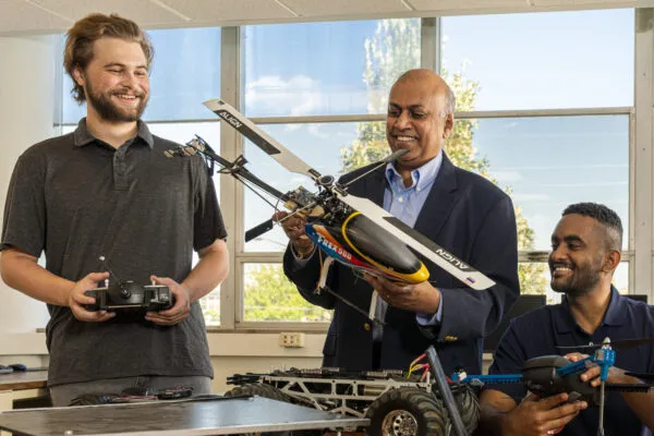 Dr. Jagannathan Sarangapani (center), a professor at Missouri S&T, discusses an unmanned aerial vehicle with doctoral students Maxwell Geiger (left) and Ahmed Abigroun. Photo by Michael Pierce/Missouri S&T. | S&T research team awarded over $2.4 million in DOD grants to study ‘smart’ unmanned vehicles 