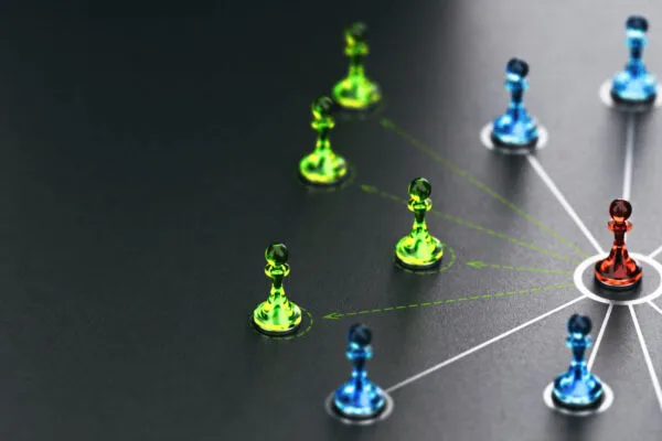 3D illustration of pawns linked together over black background. New links are represented by doted lines. Concept of new strategic alliances. | Digital Twin Consortium and OPC Foundation Announce Liaison Agreement