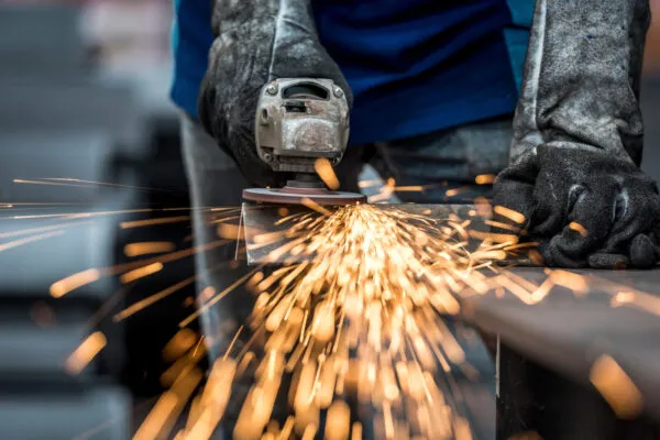 Industrial worker cutting metal with many sharp sparks | Metal-Cutting Machine Market to witness growth worth USD 10.29 Bn by 2029 Growth, Size, Share, Trends, and competitive landscape